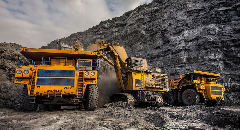 Two large trucks parked side by side in a parking area.