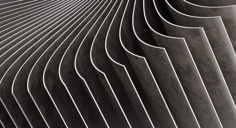 Aerospace & Defense Manufacturing A black and white photo showcasing a smooth, curved wall with subtle shadows and textures.