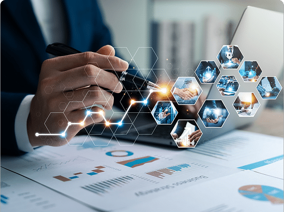 Business professional analyzing data on a laptop with charts and business icons on the desk