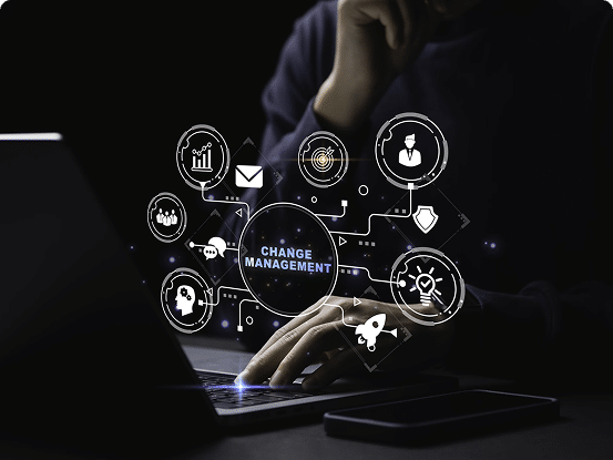 Person working on a laptop with overlaid icons and the text "CHANGE MANAGEMENT" surrounded by symbols like graphs, email, target, and rocket.