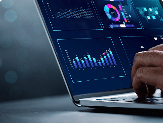 Close-up of a laptop screen showing bar graphs, line charts, and pie charts, with a hand interacting with the keyboard.