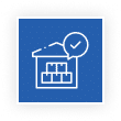 White warehouse icon with stacked boxes and a checkmark in a speech bubble on a blue background